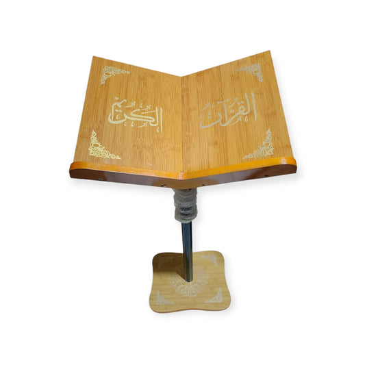 Wooden Quran stand with open pages on a white background